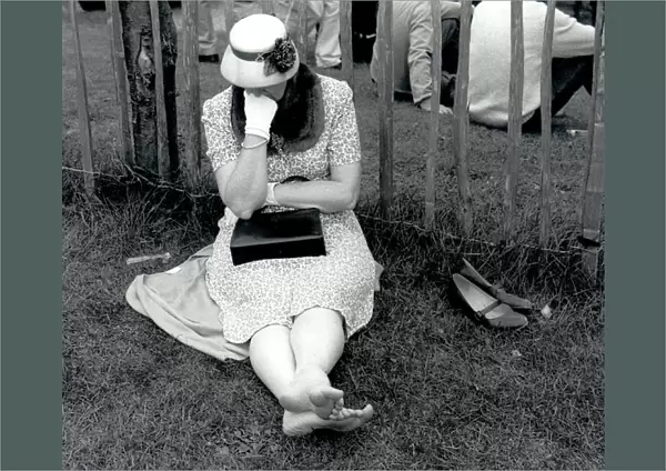 Woman resting on grass at Goodwood, West Sussex