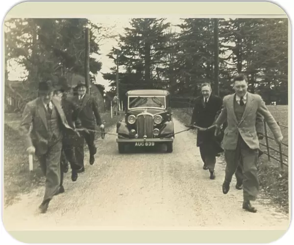 Men Towing Vintage Rover Car