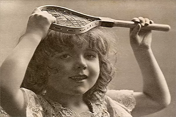 Young girl holding very little tennis racquet Date: 1905