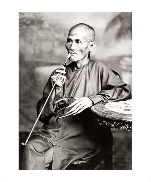 Man with long fingernails and pipe circa hina, circa 1880s. Date: circa 1880s