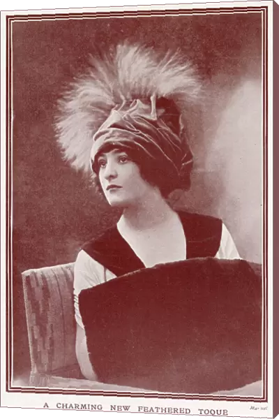 Woman wearing a fashionable velvettoque hat with plumes of feathers. Date: 1911