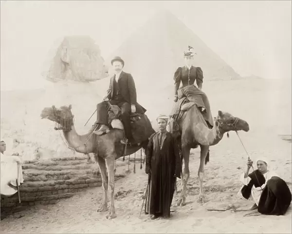 Tourists on camels with guides visiting the Sphinx