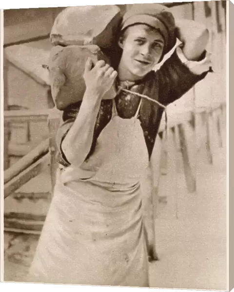 A young lad carrying the clay. Date: 1913