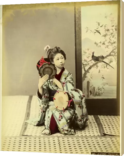Woman in kimono playing tsudzumi