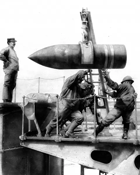 French soldiers hoisting an artillery shell