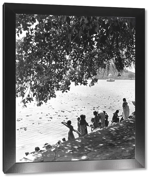 People on a riverbank, India