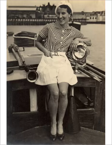 Woman poses on boat, 1930s