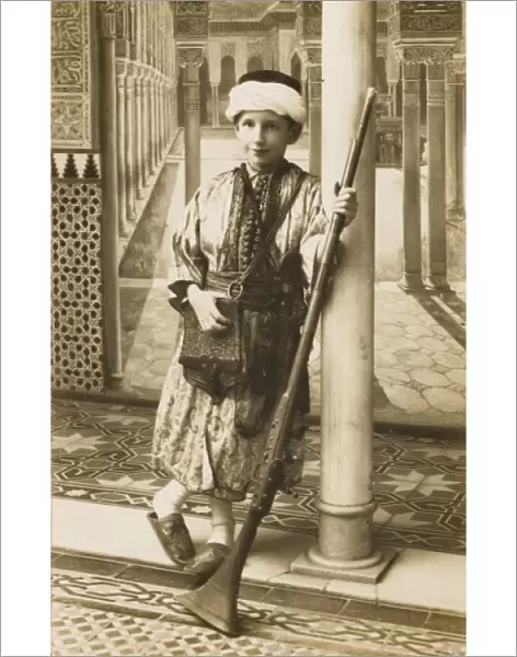 Turkish boy standing with a traditional rifle