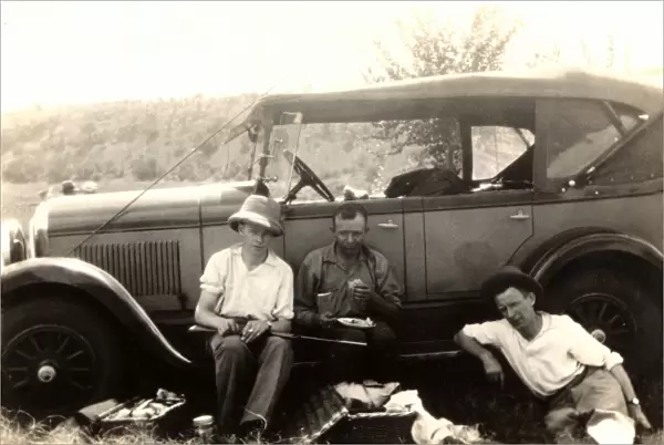 Hunting party have a picnic by their car
