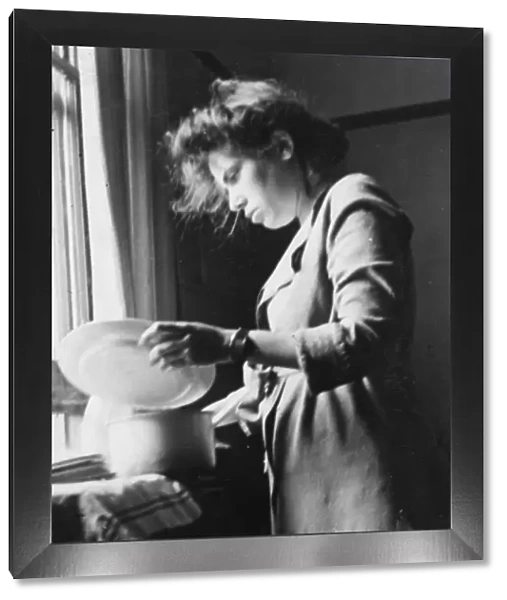 Young woman doing the washing up