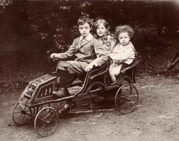 Three children in a toy car