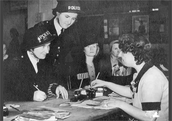 Two policewomen registering for war work