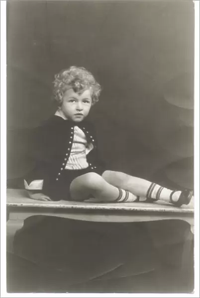 Curly haired boy in photographers studio