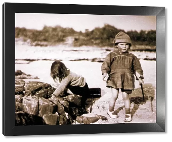 Two little girls on a beach, Scotland