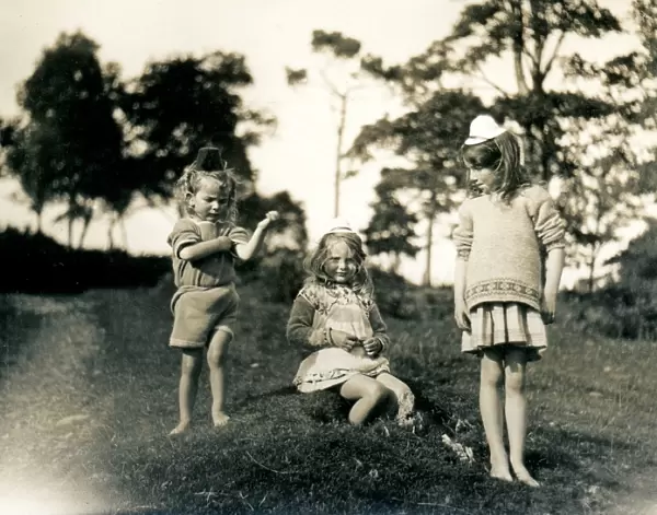 Three little girls wearing toy hats, Scotland