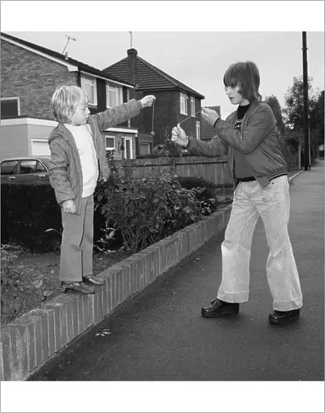 Two boys playing conkers