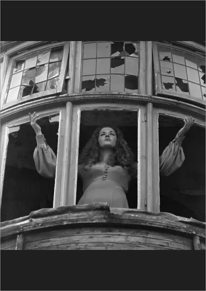Woman posing with broken windows