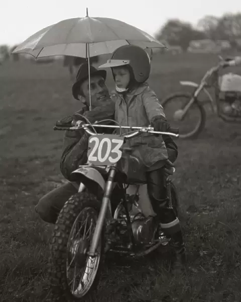 Man and boy with junior sized motorcycle