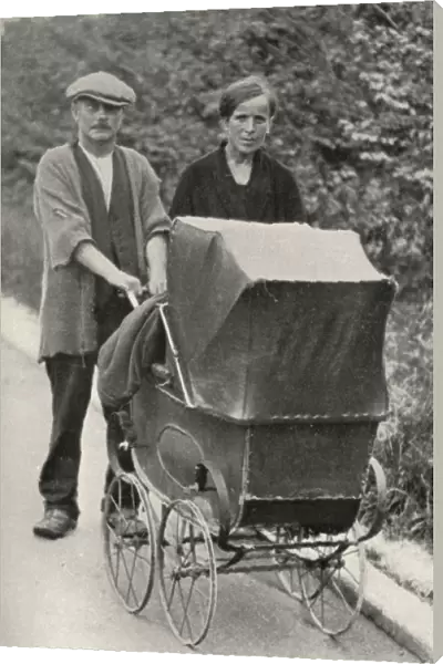 Beggar couple with child in pram