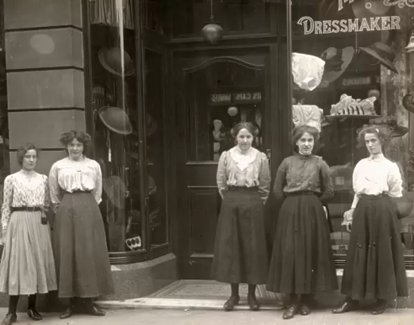 Sales assistants outside a dress shop