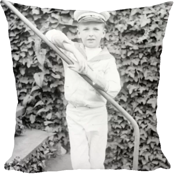 Little boy in a sailor suit in a garden, Mid Wales