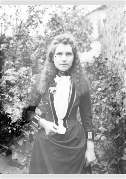 Young Edwardian woman in a garden, Mid Wales