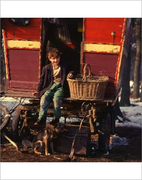 Gipsy boy sitting on the back step of his caravan