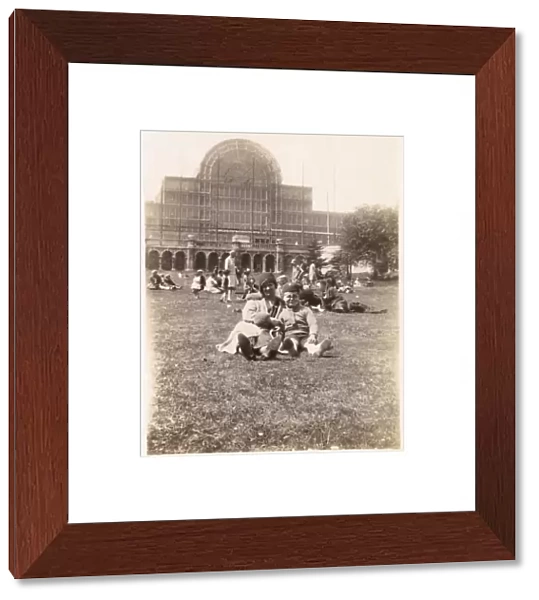 People on the grass in front of the Crystal Palace, London
