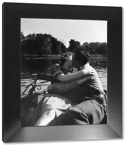 Couple kissing on boating lake
