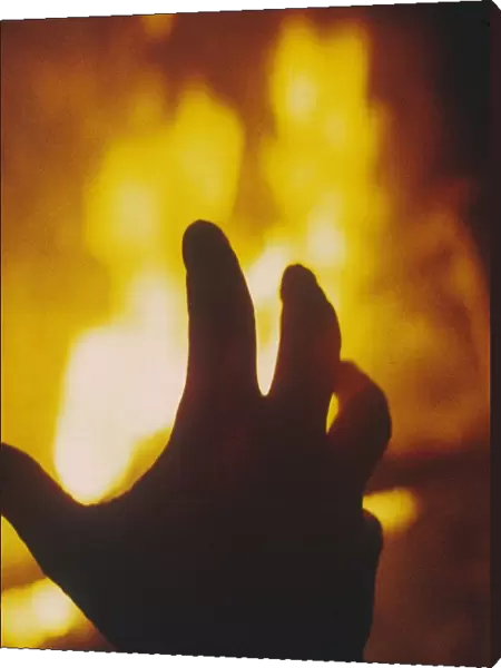 FIRE. A hand hovering over a burning flame! Date: 1971
