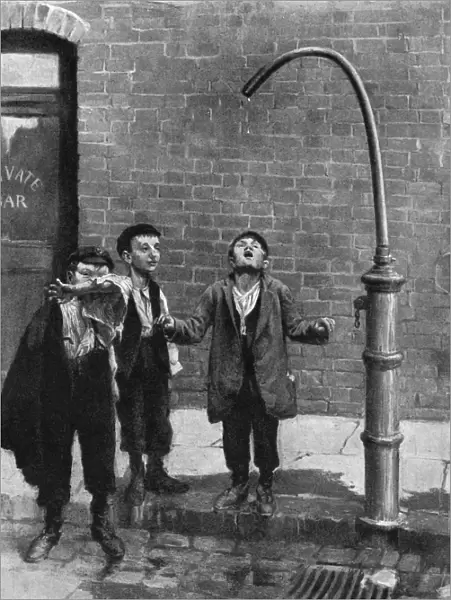 Young boys quench their thirst at a water tap