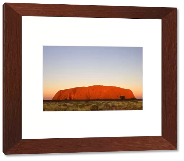 Australia - Ayers Rock - Uluru - brightly ablaze Ayers Rock at sunset - Uluru-Kata Tjuta National Park, World Heritage Area, Northern Territory. Aboriginals of the Anangu tribe call Ayers Rock Uluru