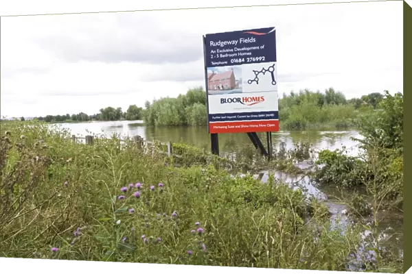 Flooding - Large bill board adverting exclusive development of new houses on inundated flood plain Newtown Tewkesbury Gloucestershire UK following unprecedented flooding of Rivers Severn and Avon July 2007