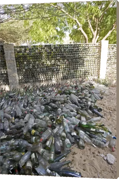 Recycling - wall built out of wine bottles. Lamu, Kenya