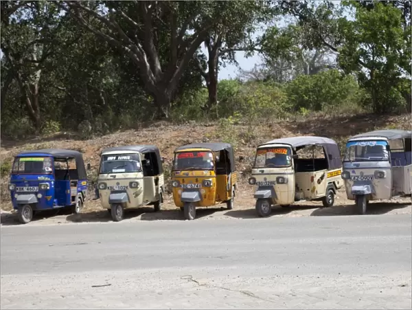 Line of Tuk-Tuk three wheeled motorised rickshaw taxis waiting for passengers Kilifi - Kenya