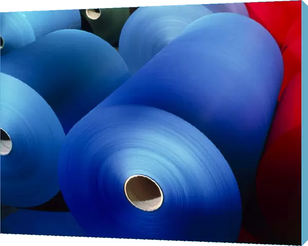 Rolls of coloured paper at a paper mill