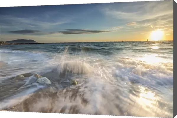 Waves crashing on the sandy beach framed by sunrise, Porto Recanati, Province of Macerata