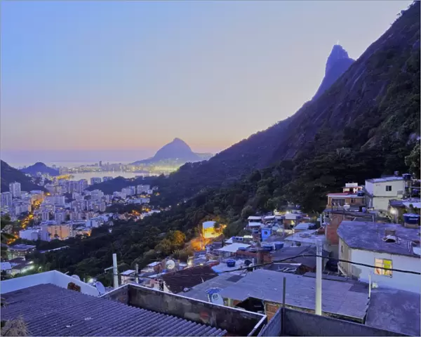Twilight view of the Favela Santa Marta with Corcovado and the Christ statue behind