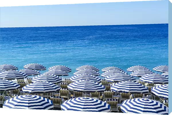Blue and white beach parasols, Nice, Alpes Maritimes, Cote d Azur, Provence, France