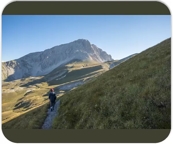 Hiker on the path to the summit of peak Corno Grande, Gran Sasso e Monti della Laga National Park