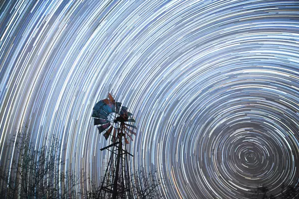 Startrail with windmill in foreground, Timbavati, South Africa, Africa