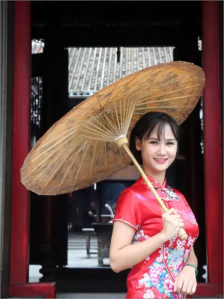 Woman wearing Vietnamese tradition dress called Ao Dai, Taoist temple
