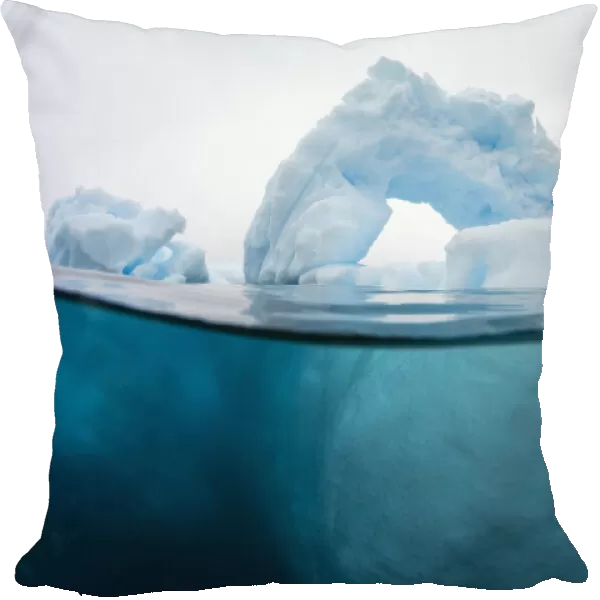 Above and below view of an arch formed in an iceberg at Cuverville Island, Ererra Channel