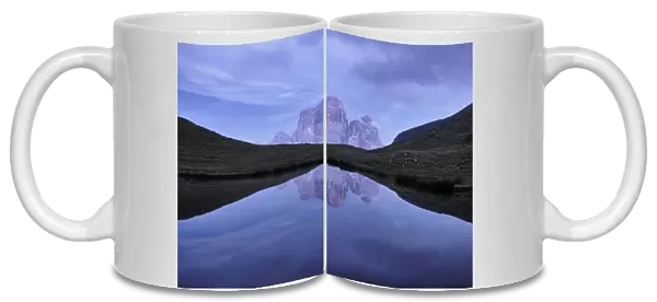 Reflection of Pelmo mountain in the Baste lake during blue hour, Dolomites