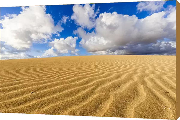 Fluffy clouds over desert sand dunes modeled by wind, Corralejo Natural Park, Fuerteventura, Canary Islands, Spain, Atlantic, Europe