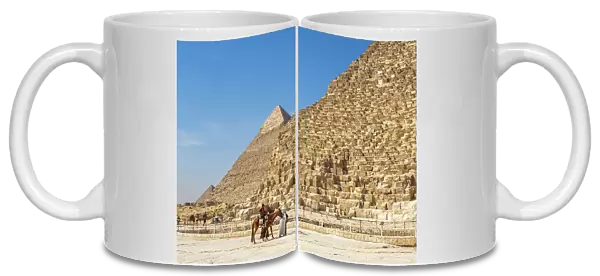 Tourists on camel ride in front of the Great Pyramid of Giza, the oldest of the Seven Wonders of the World, UNESCO World Heritage Site, Giza, near Cairo, Egypt, North Africa, Africa
