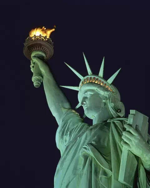 Close-up of the Statue of Liberty illuminated at night, in New York, United States of America