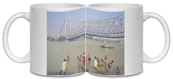 People bathing in Hooghly River, Ghat near Hooghly bridge, Kolkata (Calcutta)