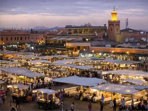 View over Djemaa el Fna at dusk with foodstalls that are set-up daily to serve tourists