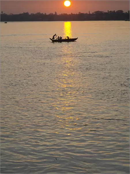 Traditional rowing boat on the river at sunset, Pathein, Irrawaddy Delta, Myamar (Burma), Asia